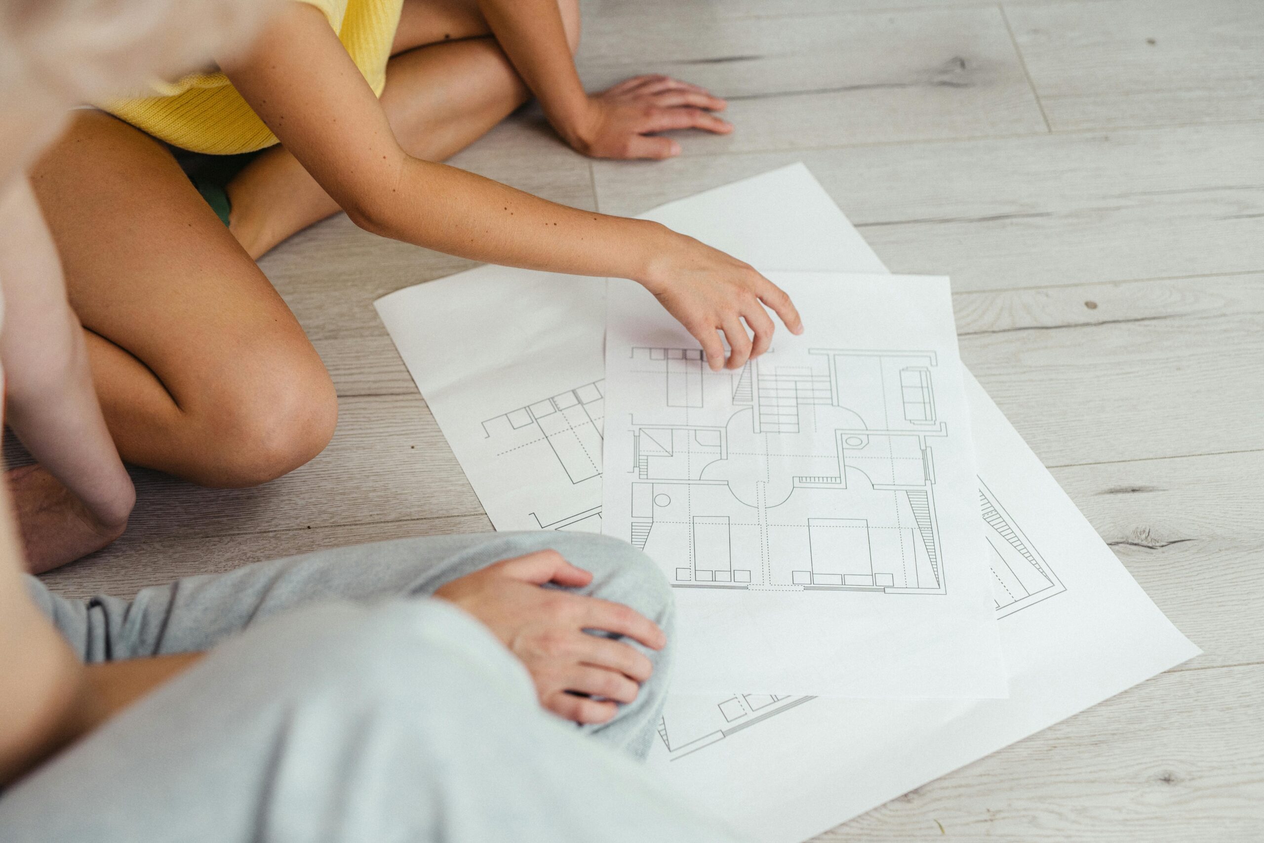 Two People Looking at a Floor Plan